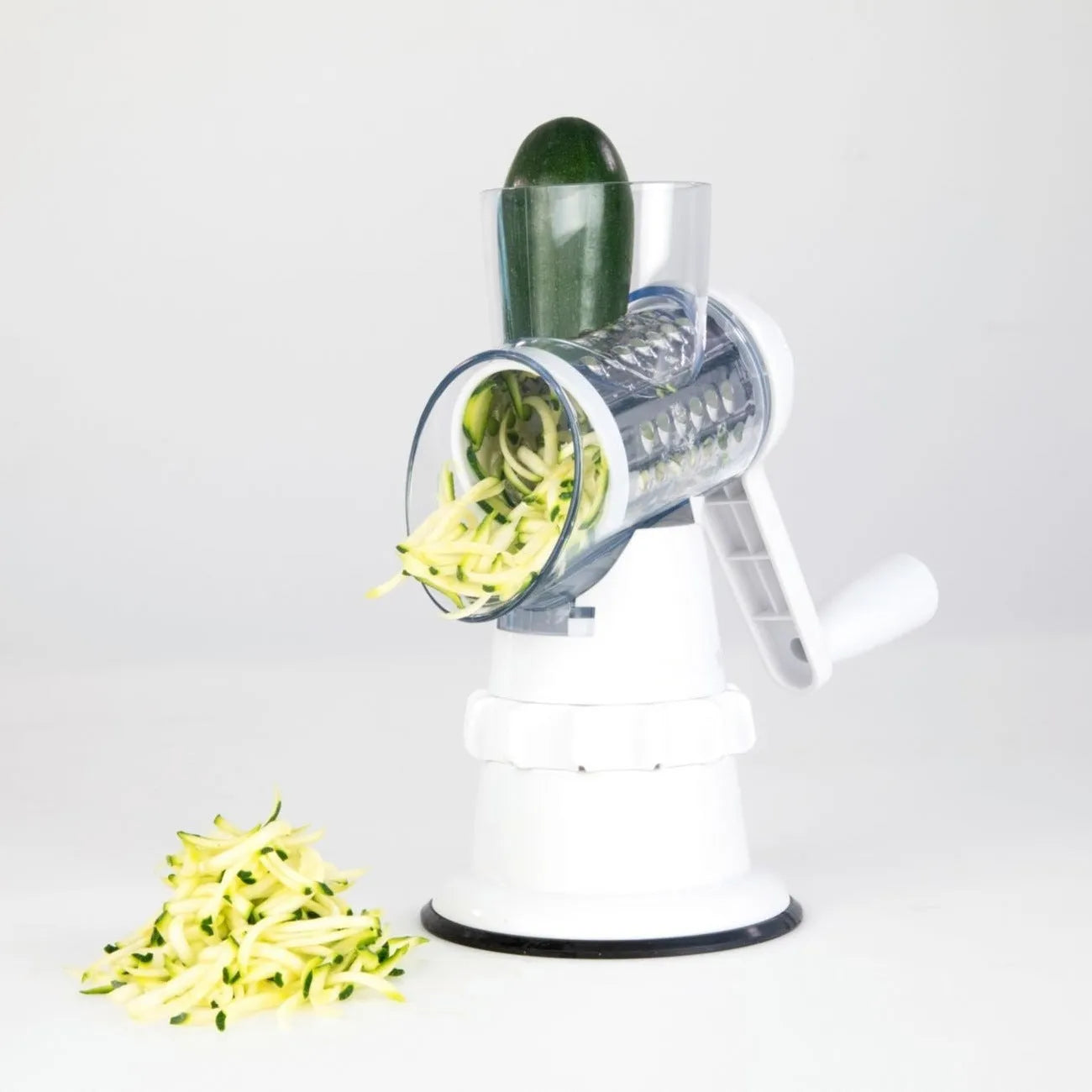 White plastic 3-in-1 manual vegetable slicer with suction feet and stainless steel blades