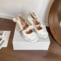Apricot chunky heel waterproof platform pumps with bow detail, square toe, and buckle fastening on a plain background