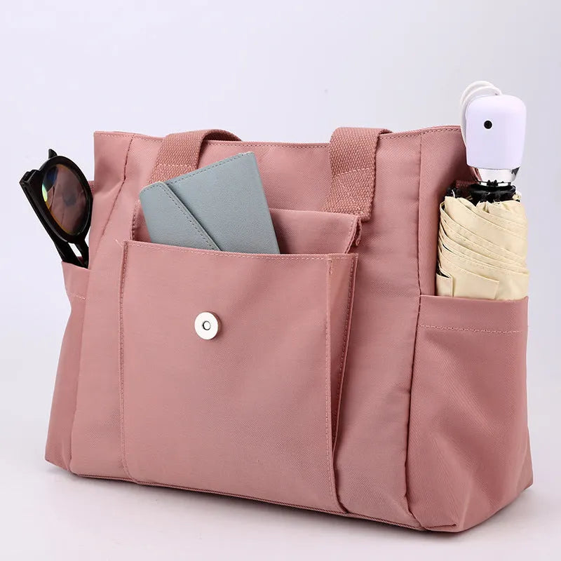 Nylon multi-interlayer shoulder bag in black with single strap and outer sandwich pocket, horizontal square shape