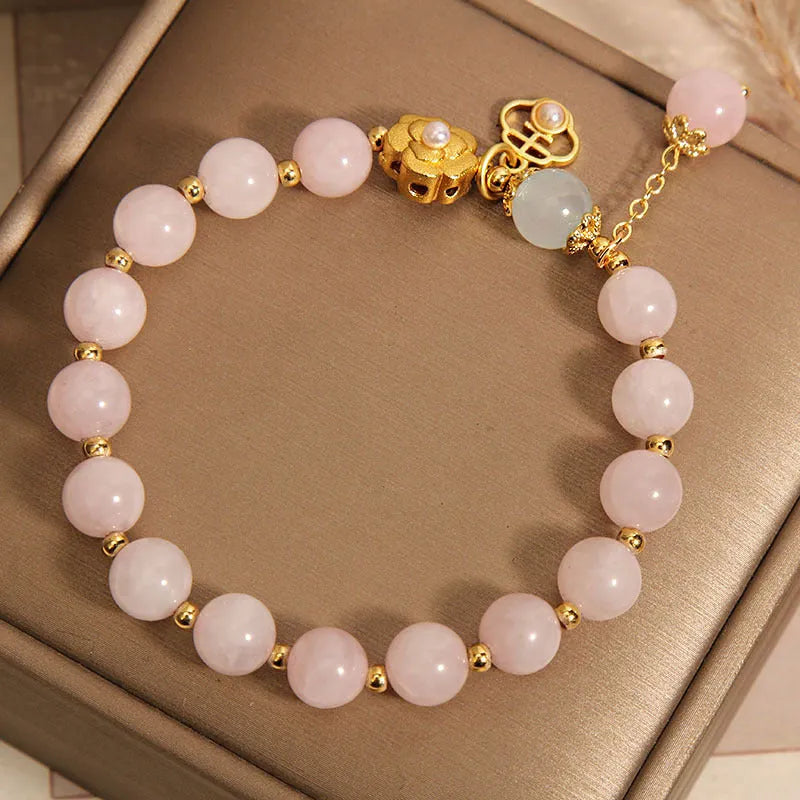 Women's pink crystal flower bracelet with detailed floral bead design on wrist