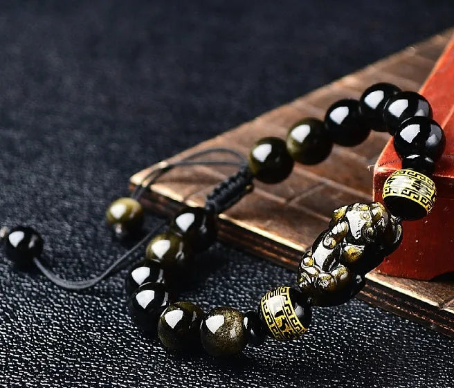 Hand-woven golden obsidian Pi Xiu bracelet with zodiac design in multiple bead sizes