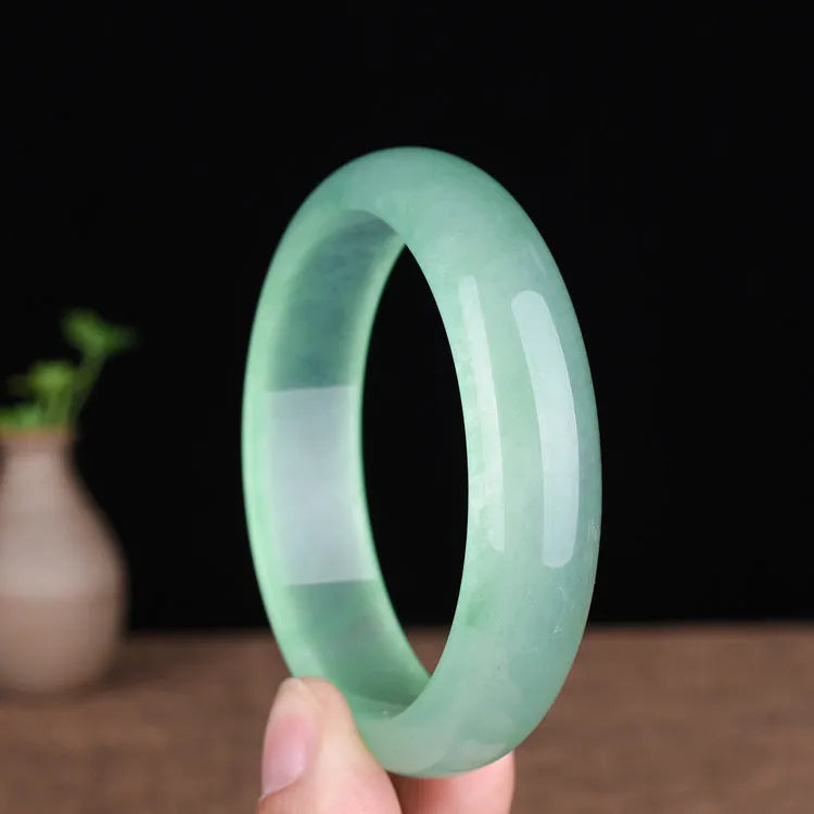 Oil cyan light green jade bracelet in modern simplicity style on wrist