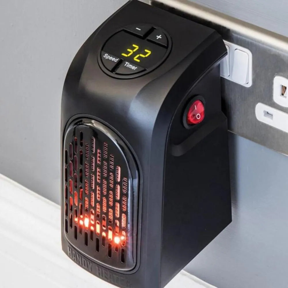 Small black ceramic fan heater with control buttons on top, showing plug and compact size.
