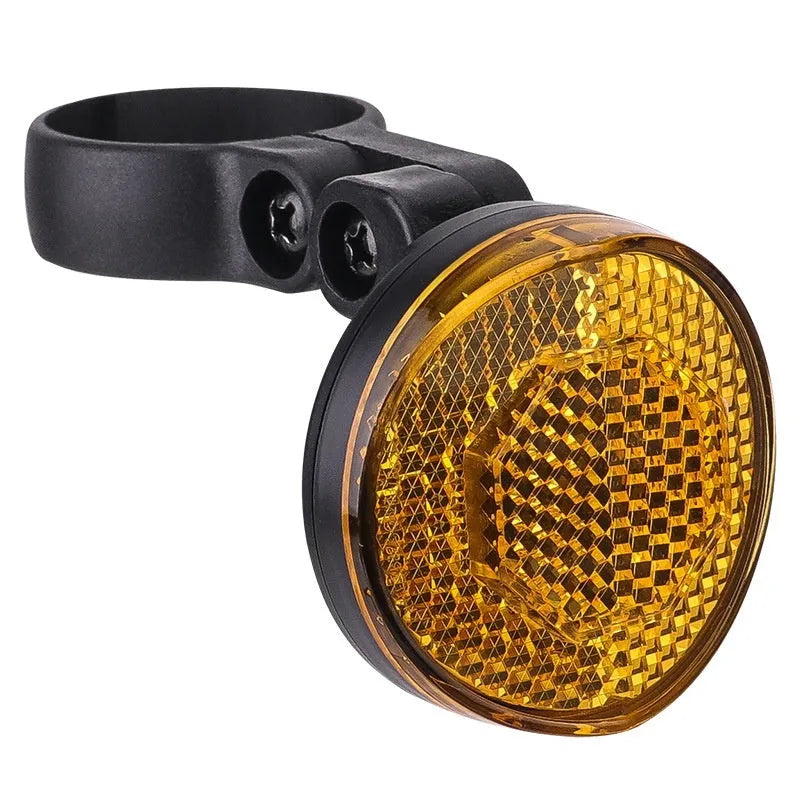 Red plastic anti-theft bicycle taillight bracket with integrated reflector mounted on a seat post.