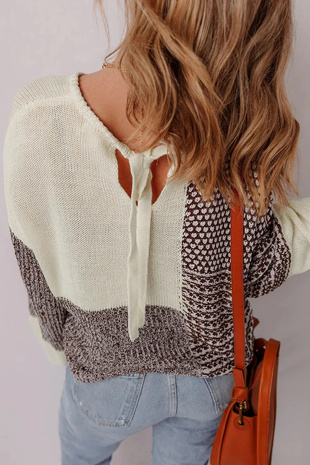 Dark khaki loose drop shoulder sweater with a colour block back panel and tie detail.