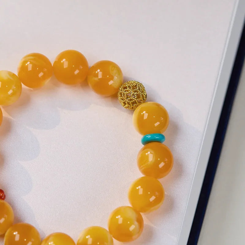 Natural beeswax Gourd Fu Lu bracelet in two sizes 12mm and 6mm on plain background