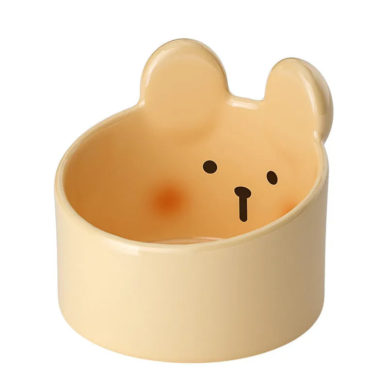 White and yellow ceramic pet bowls with rabbit and bear motifs in two sizes