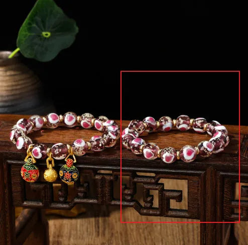 Handmade glass bracelet with swallowing gold beast design on heart-shaped 10mm beads