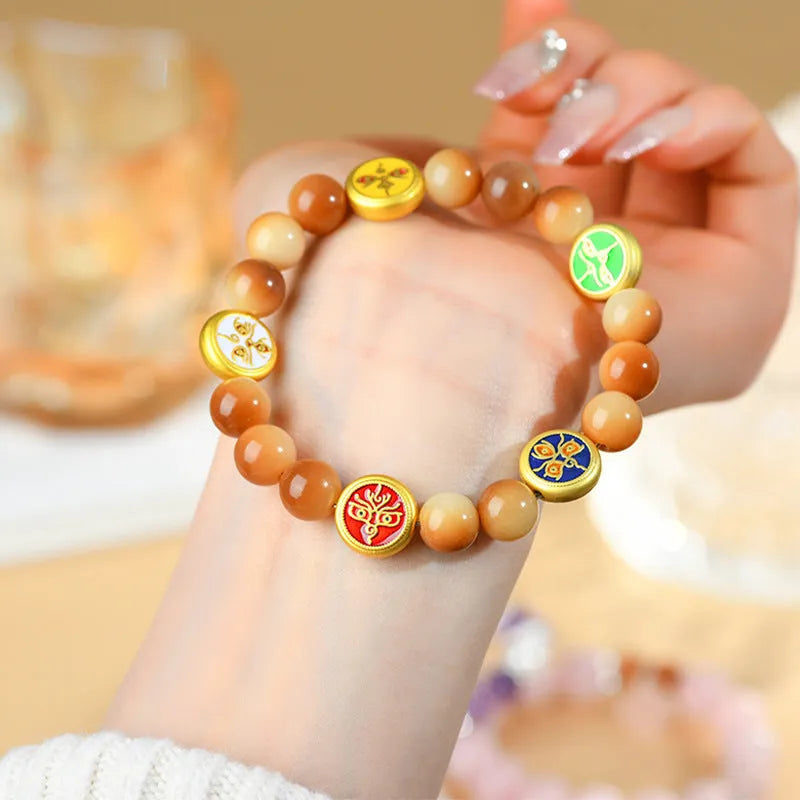 Yellow bodhi seed bracelet with geometric shapes measuring 14-17 inches