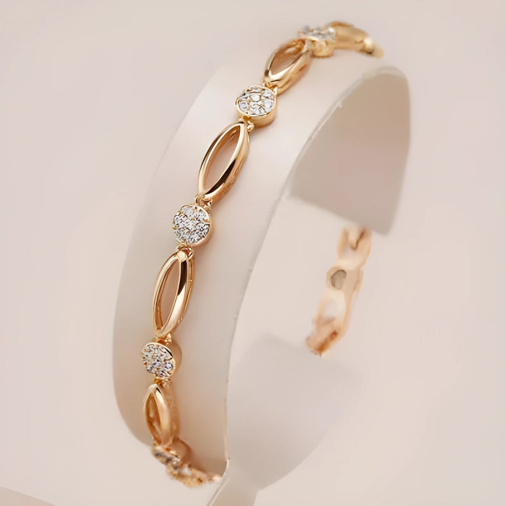 Golden coloured hollow carved copper bracelet with a U-shaped bangle profile on a white background.