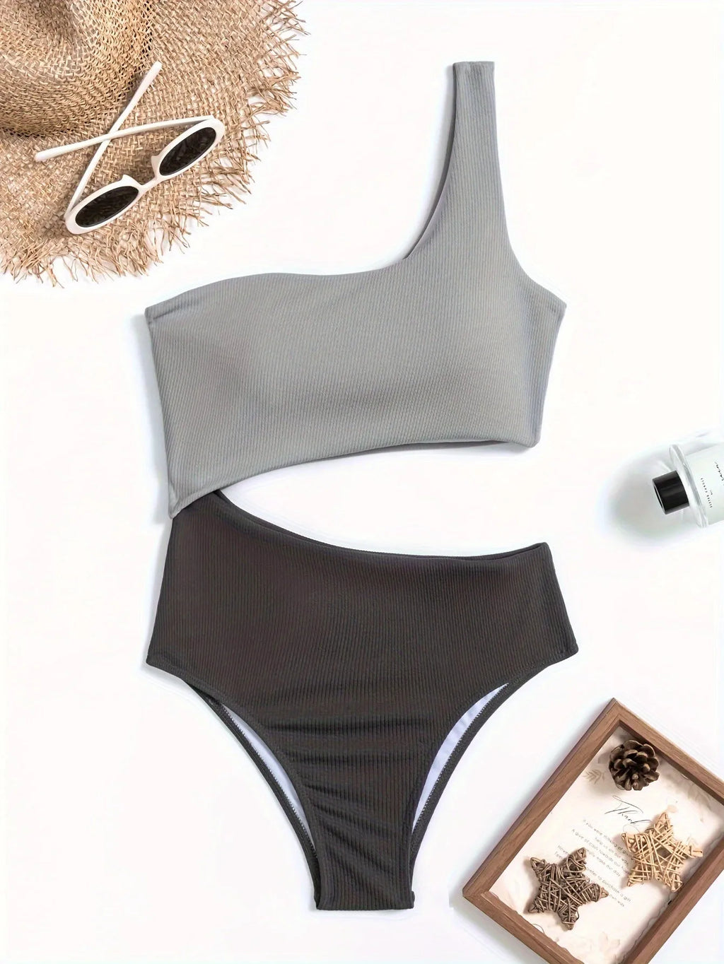 Light grey women's one-shoulder one-piece swimsuit on a model
