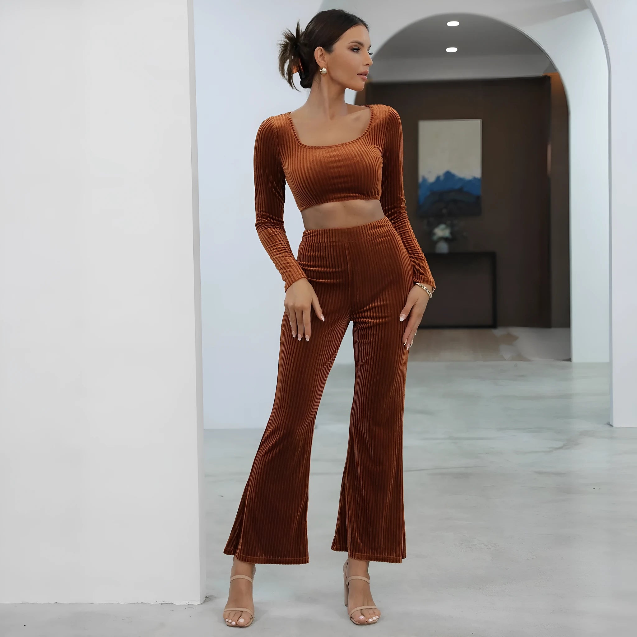 Caramel coloured long sleeve sweater and trouser set laid flat, showing casual two-piece design.