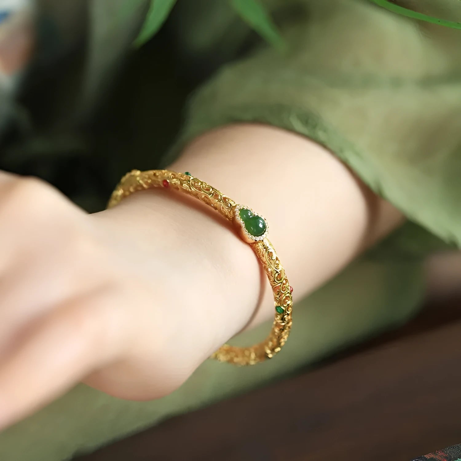 Gold-toned open design gourd charm bracelet with a dark adjustable silk cord for women.