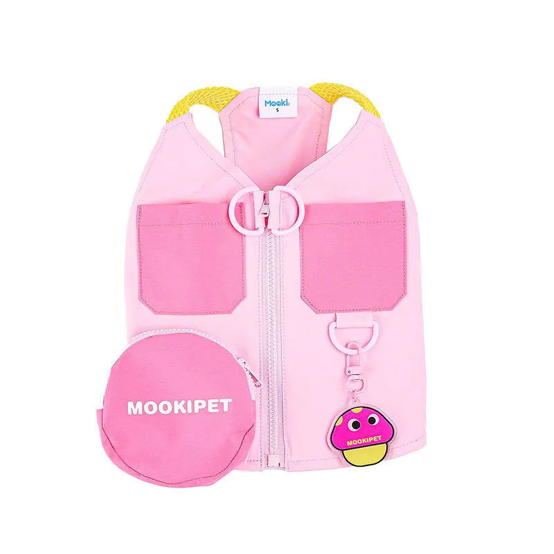 Pink polyester traction vest for small dogs on a Bichon Frisé, showing casual style and lead attachment point.
