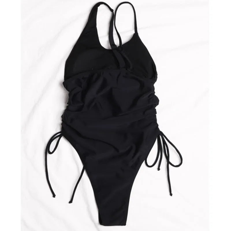 Black tight-fitting sleeveless women's dress with lacing detail and sloping shoulders.