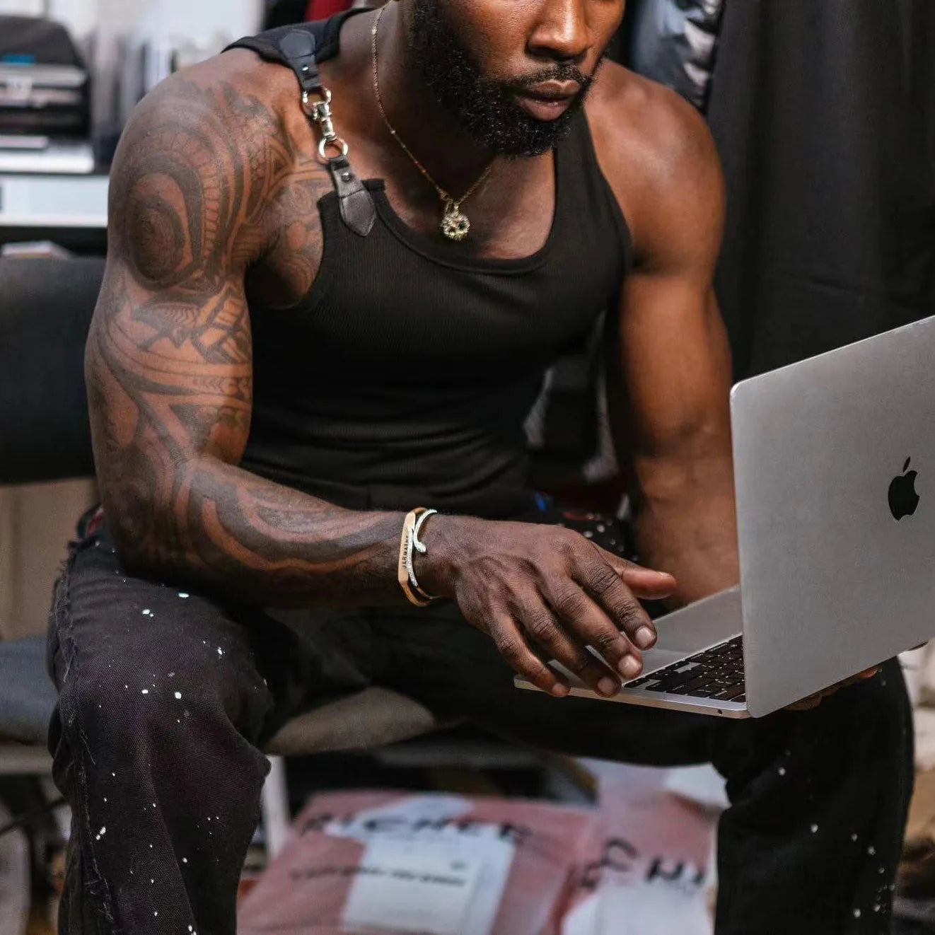A solid black or white sleeveless cotton blend vest on a hanger, showing its tight-fit style.