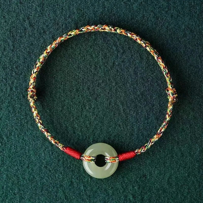 Colourful braided rope bracelet with peace buckle fastening in woven unisex design