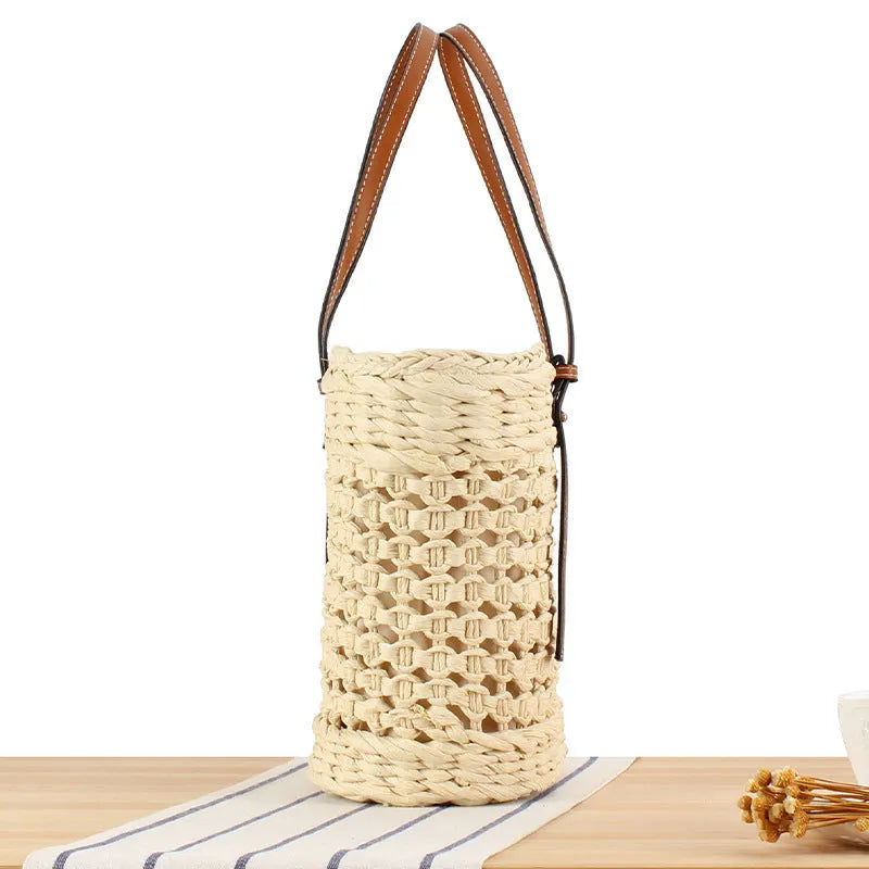 Beige horizontal square woven paper-string shoulder bag showing wide opening and adjustable strap