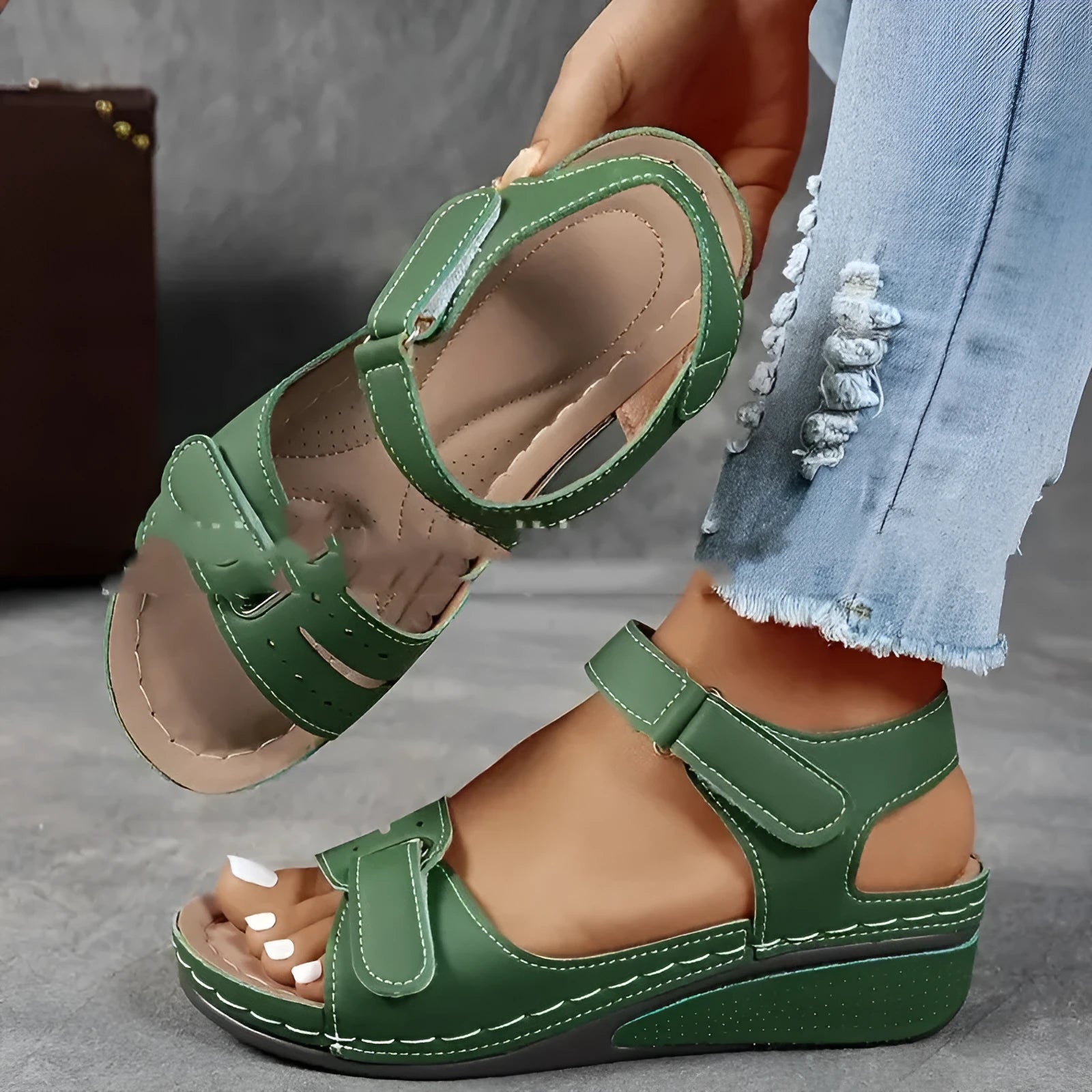 Women's beige thick-soled sandals with adjustable black Velcro straps on a white background.