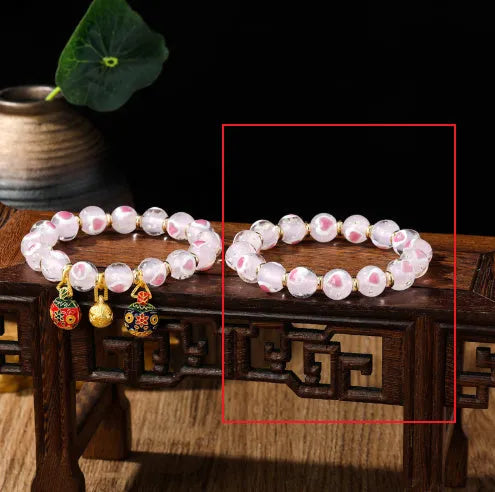Handmade glass bracelet with swallowing gold beast design on heart-shaped 10mm beads