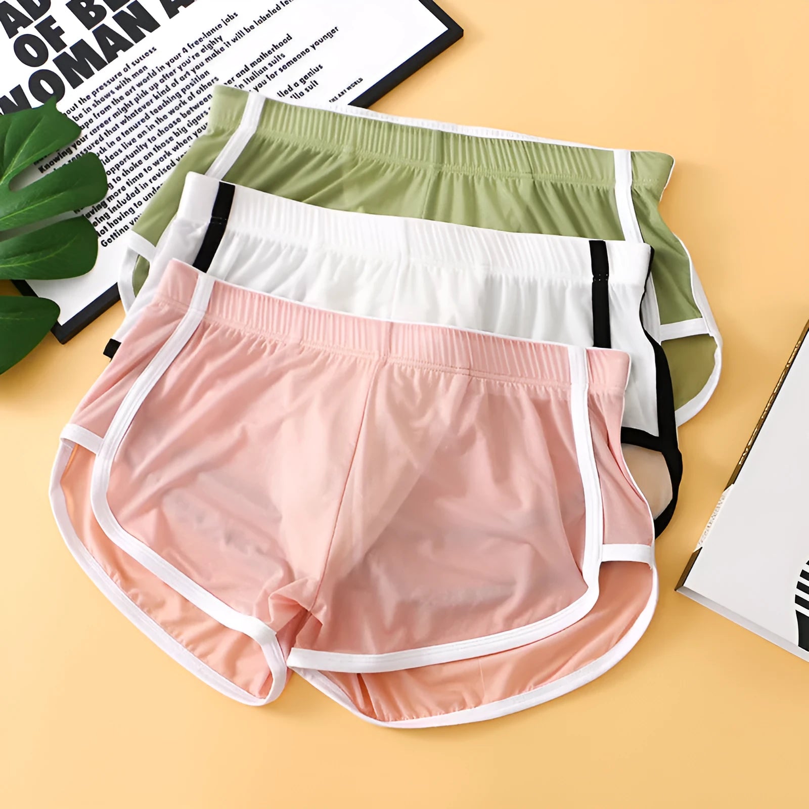 Men's black ice silk mesh boxer briefs with a low waist design on a plain background.