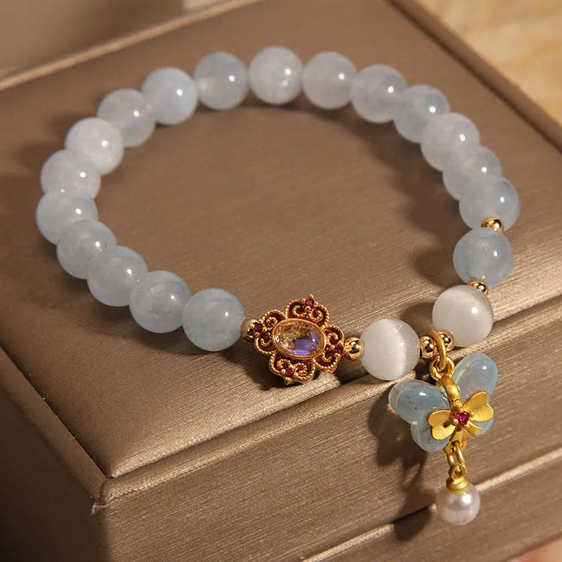 Women's crystal bracelet with aquamarine butterfly pendant and rhinestone details