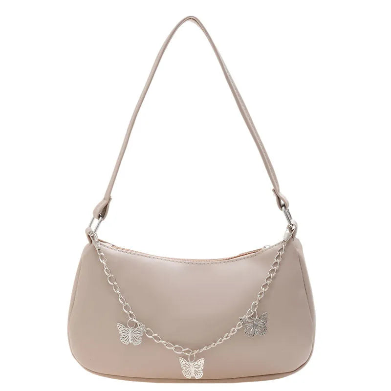 Retro-style light blue underarm shoulder bag with a silver butterfly chain strap, shown worn crossbody.