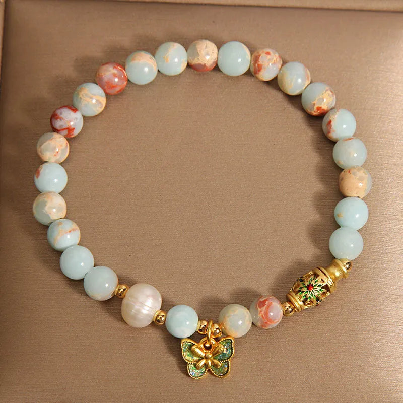 Blue women's bracelet with Shoushan stone, freshwater pearls and butterfly charm pendant
