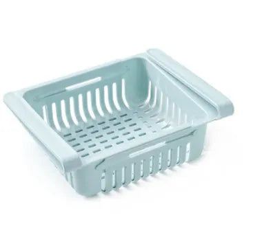 Blue telescopic plastic storage basket for refrigerator organisation with fruits and vegetables inside.