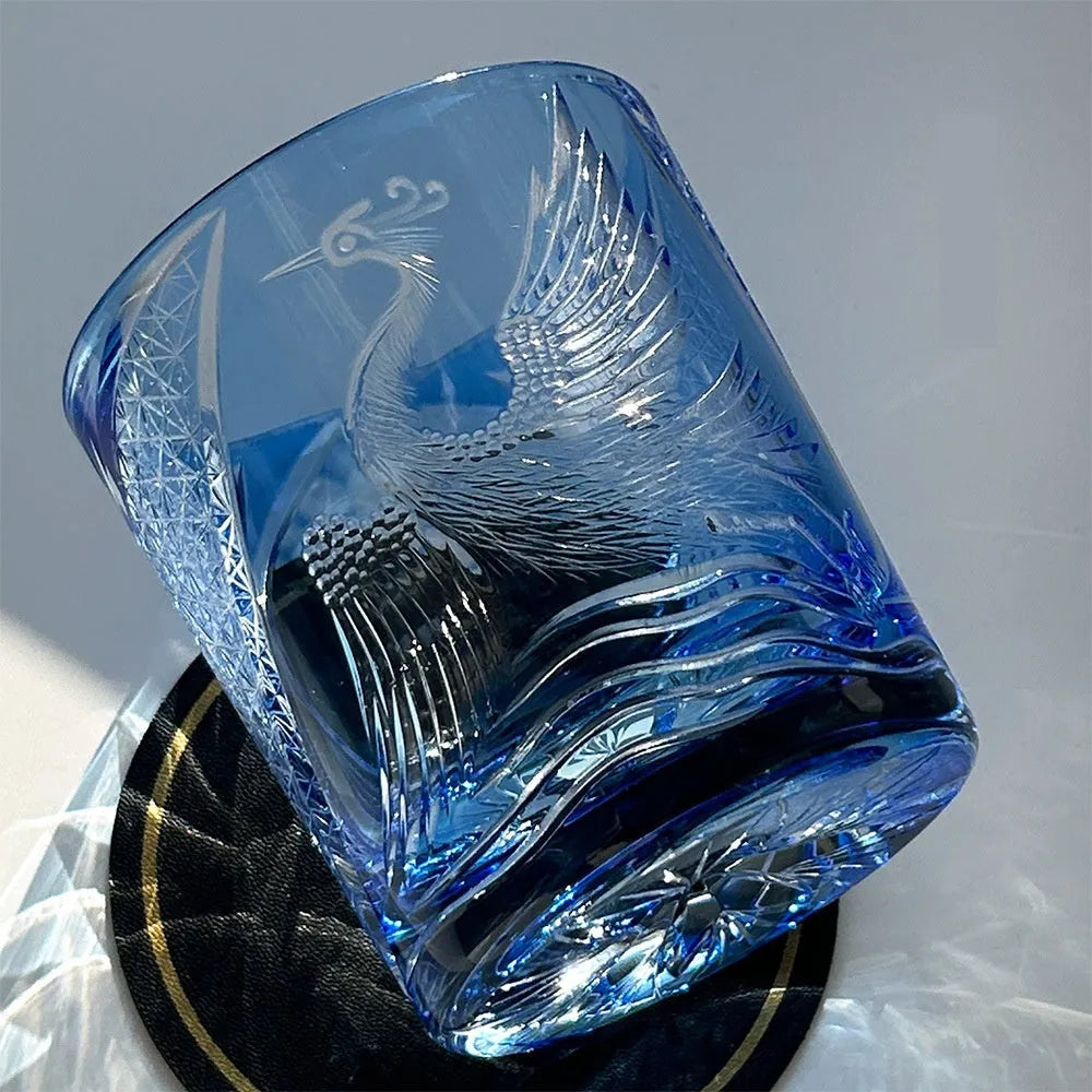 Hand carved crystal whiskey shot glass in sky blue with crane motif, 90x100mm