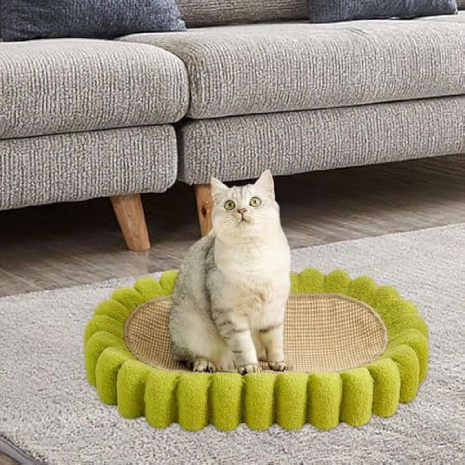 Green oval cat scratcher pad with sisal material and integrated cat bed bowl design