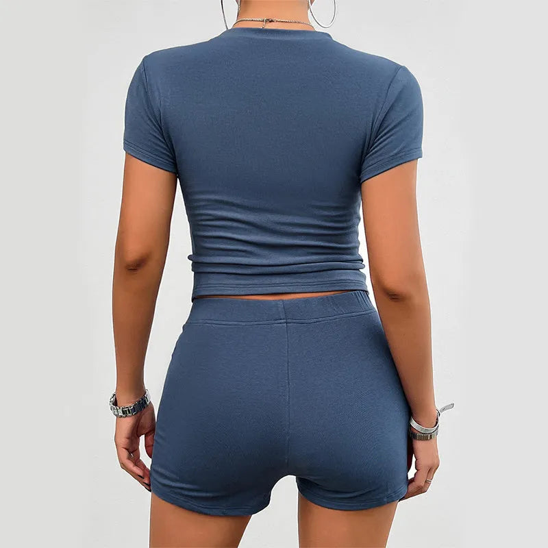 Women's solid colour viscose sports set with round neck T-shirt and elastic shorts on a hanger.