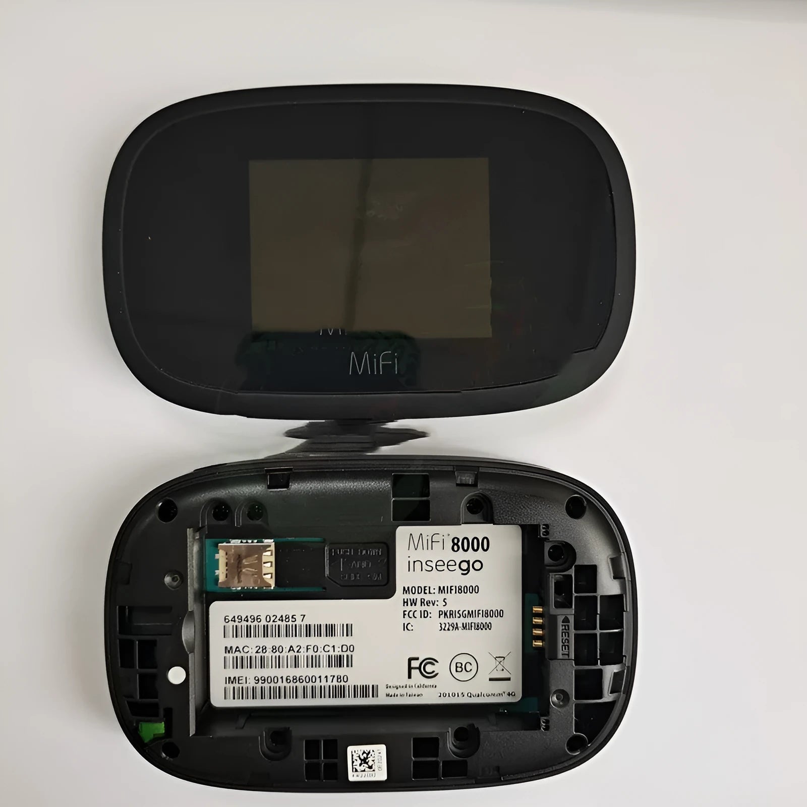 Black mifi8000 4G portable WiFi router with removable battery on a table