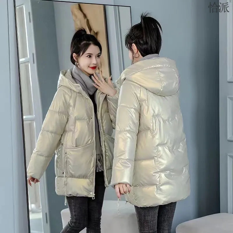 A woman's loose-fit hooded winter jacket in a poly-cotton blend, shown in a choice of colours including black and champagne.