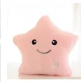 Colourful glowing five-pointed star plush pillow on a dark background, showing soft texture and LED illumination