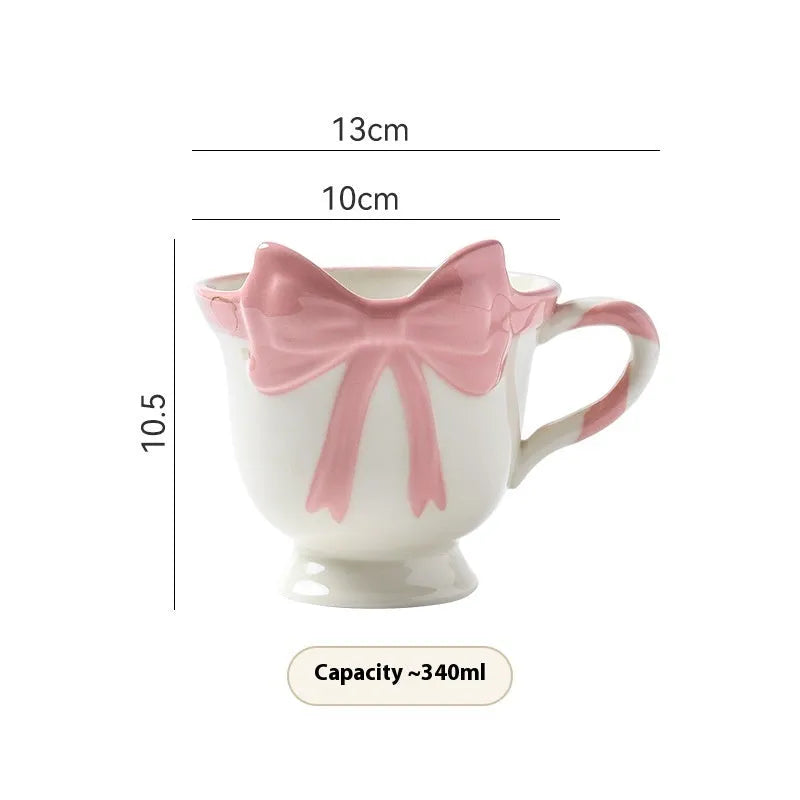 Ceramic mug with heart bow design in black pink and white powder colour options