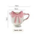 Ceramic mug with heart bow design in black pink and white powder colour options