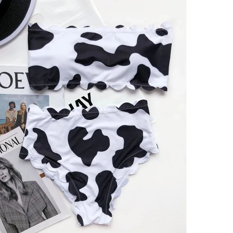 Black and white cow print wrapped breast bikini set on a model, nylon fabric, black and white animal pattern, adjustable wrap front top
