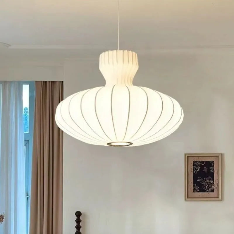 Vintage Chinese-style chandelier with a multi-arm design and glass shades, shown in a dining room setting.