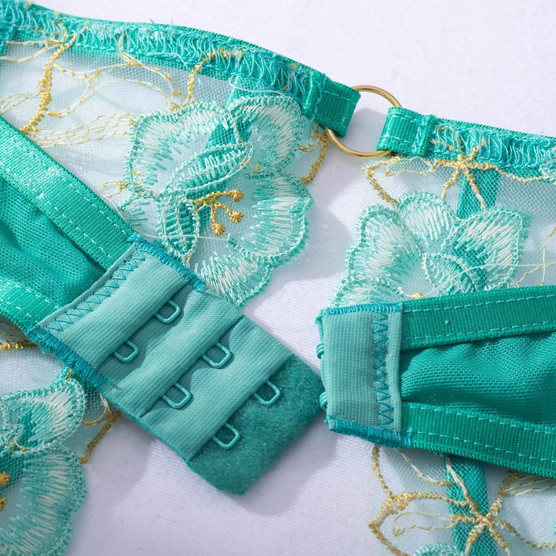 Light green women's embroidered bra and bikini set on a white background