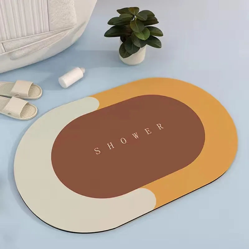 Oval grey polyester door mat with textured rubber non-slip backing on a wooden floor.