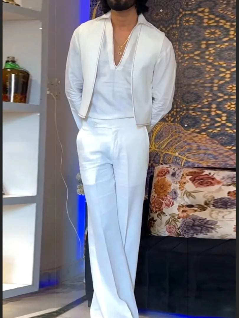 White three-piece outfit comprising V-neck shirt, sleeveless vest and trousers on hanger