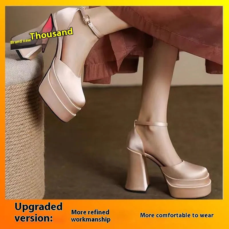 Women's white chunky heel platform pumps with a round toe and ankle strap on a plain background.