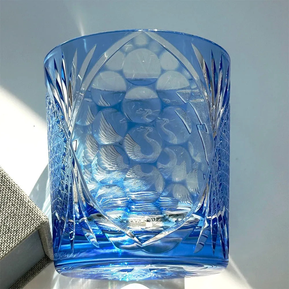 Hand carved crystal whiskey shot glass in sky blue with crane motif, 90x100mm