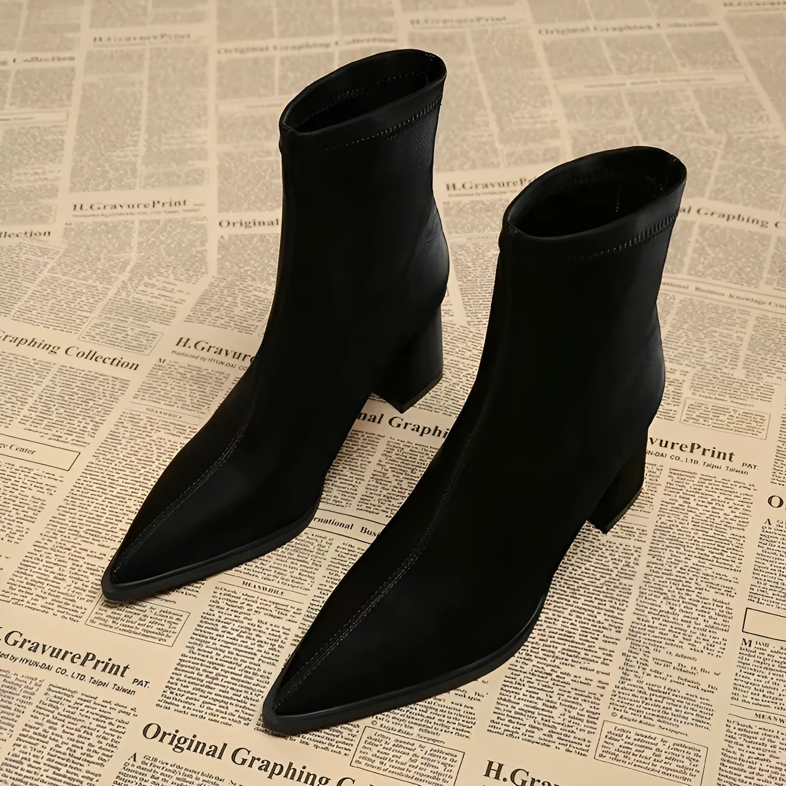 Women's khaki pointed toe ankle boots with a wedge heel on a white background.