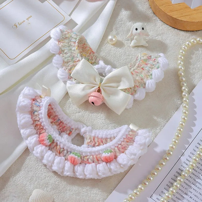 Handmade woven wool cat collar with embroidered cartoon British Shorthair kitten in pink, white, and yellow colours.
