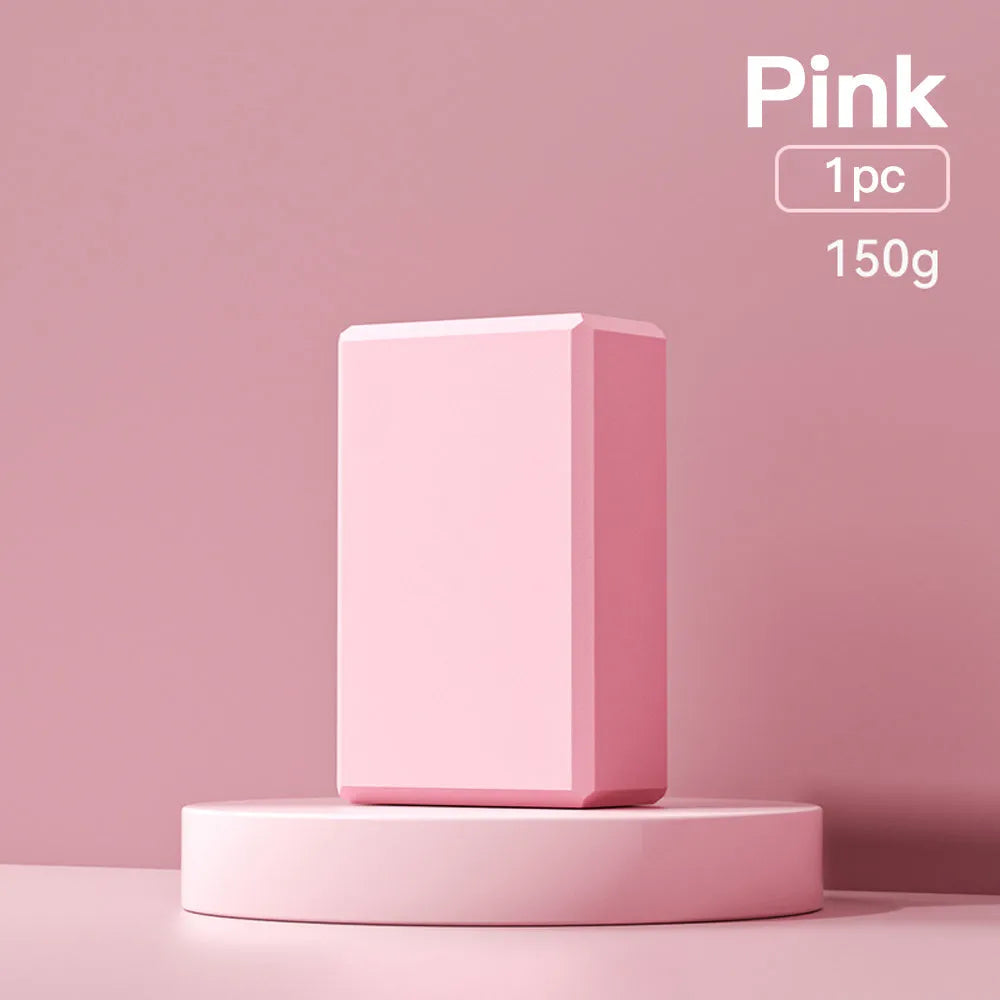 Solid blue EVA foam yoga brick with ridged hexagonal surface, shown next to a pink block.