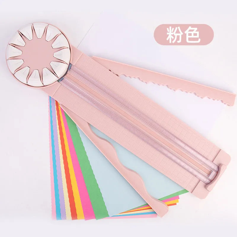 Pink and black 12-in-1 decorative edge paper cutting machine for A4 paper on a desk.