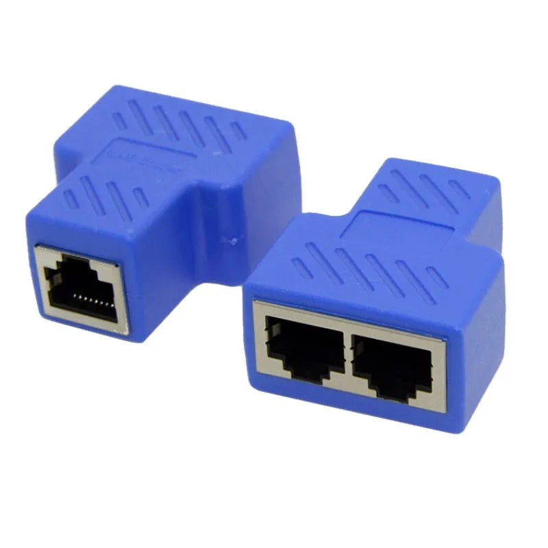 White RJ45 three-way tee network cable splitter adapter on a table.