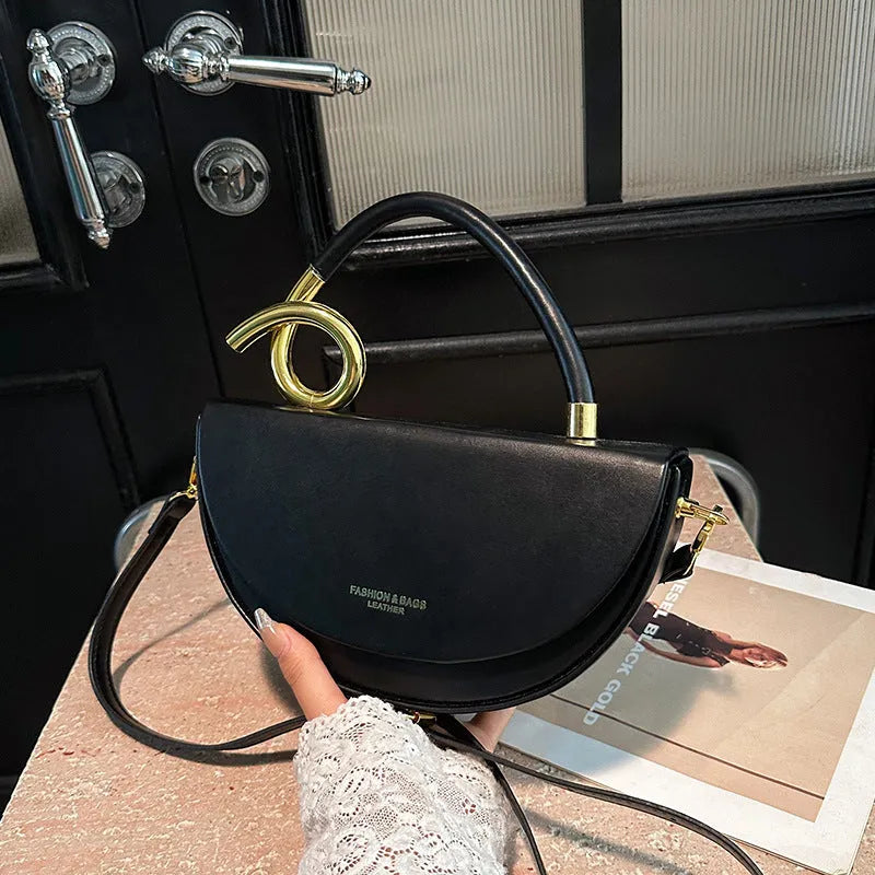 Medium hard PU box saddle bag in solid colour with internal zipper pocket and oval shape